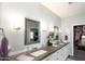 Bright bathroom featuring double sinks, stylish mirrors, and ample counter space leading to closet at 943 E Kortsen Rd # 10, Casa Grande, AZ 85122