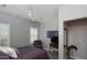Comfortable bedroom featuring a ceiling fan, shuttered windows, and a chair and TV at 943 E Kortsen Rd # 10, Casa Grande, AZ 85122