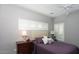 Cozy bedroom showcasing a comfortable bed, shuttered windows, and a classic nightstand with a lamp at 943 E Kortsen Rd # 10, Casa Grande, AZ 85122