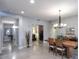 Open-concept dining area showcasing a contemporary chandelier and a large wooden dining table at 943 E Kortsen Rd # 10, Casa Grande, AZ 85122