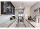 Hallway with white cabinets and countertops, offering ample storage and counter space, leading to the kitchen at 943 E Kortsen Rd # 10, Casa Grande, AZ 85122
