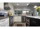 An open kitchen showcasing white cabinets, stainless steel appliances, and an island with a marble countertop at 943 E Kortsen Rd # 10, Casa Grande, AZ 85122