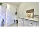 Bright laundry room with cabinets, granite countertop, utility sink, and stylish decor at 943 E Kortsen Rd # 10, Casa Grande, AZ 85122