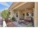 Relaxing covered patio featuring comfortable seating, ceiling fan, and desert landscaping at 943 E Kortsen Rd # 10, Casa Grande, AZ 85122