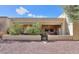 Comfortable covered patio with neutral stucco, seating area, ceiling fan, and gravel landscaping at 943 E Kortsen Rd # 10, Casa Grande, AZ 85122
