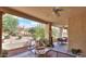 Inviting covered patio with seating, ceiling fan, desert landscaping, and peaceful ambiance at 943 E Kortsen Rd # 10, Casa Grande, AZ 85122