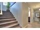 Carpeted staircase leading to a bright hallway with decorative plants and inviting decor at 943 E Kortsen Rd # 10, Casa Grande, AZ 85122