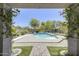 Backyard featuring a kidney shaped pool, patio, and desert landscaping at 9805 W Caron Dr, Peoria, AZ 85345