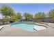 Backyard featuring a freeform pool, patio, desert landscaping, and block wall at 9805 W Caron Dr, Peoria, AZ 85345