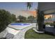 Beautiful backyard view from the covered patio showcasing outdoor living, pool, and lush landscaping at 9805 W Caron Dr, Peoria, AZ 85345