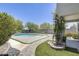 Lush backyard featuring a uniquely shaped pool and desert landscaping at 9805 W Caron Dr, Peoria, AZ 85345