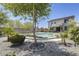 Secluded backyard with a beautiful pool, lush landscaping, and a charming two-story home at 9805 W Caron Dr, Peoria, AZ 85345