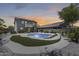 Inviting backyard with a sparkling pool, desert landscaping, solar panels, and privacy fencing at 9805 W Caron Dr, Peoria, AZ 85345