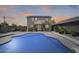 Inviting backyard pool with lush landscaping and a charming two-story home, perfect for outdoor relaxation and entertainment at 9805 W Caron Dr, Peoria, AZ 85345