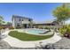 Inviting backyard featuring a sparkling pool, desert landscaping, solar panels, and privacy fencing at 9805 W Caron Dr, Peoria, AZ 85345