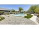 Backyard with a freeform pool, artificial turf, patio, and lush landscaping at 9805 W Caron Dr, Peoria, AZ 85345