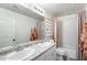Bathroom with double sinks, white cabinets, and shower-tub combination at 9805 W Caron Dr, Peoria, AZ 85345