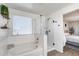 Bright, modern bathroom featuring glass shower, soaking tub, and decorative shelving at 9805 W Caron Dr, Peoria, AZ 85345