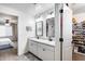 Bright bathroom with a double vanity, view to bedroom, and a separate walk in closet at 9805 W Caron Dr, Peoria, AZ 85345