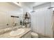 Well-lit bathroom featuring a sink with granite countertops, modern fixtures, and a shower at 9805 W Caron Dr, Peoria, AZ 85345