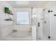 Relaxing bathroom featuring shower, tub, subway tile, and decorative shelving at 9805 W Caron Dr, Peoria, AZ 85345