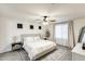 Inviting bedroom with a cozy bed, soft lighting from bedside lamps, and a ceiling fan for added comfort at 9805 W Caron Dr, Peoria, AZ 85345