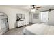 Bright bedroom featuring a white dresser, decorative artwork, and a ceiling fan for comfort at 9805 W Caron Dr, Peoria, AZ 85345