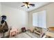 Cozy bedroom with neutral walls, ceiling fan, and a window providing natural light at 9805 W Caron Dr, Peoria, AZ 85345