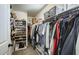 Spacious walk-in closet with organized shelving and hanging rods, perfect for wardrobe storage and organization at 9805 W Caron Dr, Peoria, AZ 85345