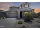 Beautiful two-story home featuring a tile roof, desert landscaping, and attached two-car garage at 9805 W Caron Dr, Peoria, AZ 85345