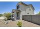 Side view of charming two-story home featuring desert landscaping and an attached two-car garage at 9805 W Caron Dr, Peoria, AZ 85345