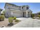 Charming two-story home featuring a tile roof, desert landscaping, and an attached two-car garage at 9805 W Caron Dr, Peoria, AZ 85345