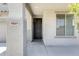 Welcoming front entrance featuring a black door, textured walls, and visible house number at 9805 W Caron Dr, Peoria, AZ 85345