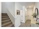 Hallway with a staircase, modern decor, light wood floors, and white walls at 9805 W Caron Dr, Peoria, AZ 85345