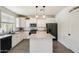 Modern kitchen with white cabinets, a center island, stainless steel appliances, and tile backsplash at 9805 W Caron Dr, Peoria, AZ 85345