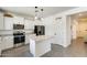 Contemporary kitchen with white cabinetry, stainless steel appliances, and a center island at 9805 W Caron Dr, Peoria, AZ 85345