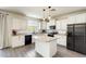 Modern kitchen featuring white cabinetry, granite countertops, and stainless steel appliances at 9805 W Caron Dr, Peoria, AZ 85345