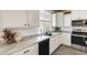 Bright kitchen featuring white cabinetry, stainless steel appliances, and a modern design at 9805 W Caron Dr, Peoria, AZ 85345