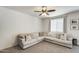 Bright living room with a corner sectional sofa and a window, offering a relaxing seating area at 9805 W Caron Dr, Peoria, AZ 85345