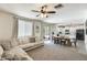 Open-concept living area with a comfortable couch, dining table, and an view of the modern kitchen at 9805 W Caron Dr, Peoria, AZ 85345