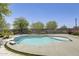Inviting backyard pool featuring cool, refreshing water with tanning shelf and surrounding patio at 9805 W Caron Dr, Peoria, AZ 85345