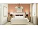 Well-appointed bedroom with stylish wallpaper, bedside tables, and a cozy bed with decorative pillows at 9830 W Pinchot Ave, Phoenix, AZ 85037