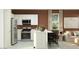 Modern kitchen with stainless steel appliances and a center island at 9830 W Pinchot Ave, Phoenix, AZ 85037