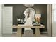 Stylish home office setup with a sleek desk, comfortable seating, and ample lighting at 9830 W Pinchot Ave, Phoenix, AZ 85037