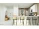 Modern kitchen with a center island, bar stool seating, and stainless steel appliances, creating a functional and stylish space at 9839 W Pinchot Ave, Phoenix, AZ 85037