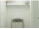 Bright laundry room with open shelving, basket, towels and a triple laundry hamper at 9839 W Pinchot Ave, Phoenix, AZ 85037