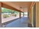 Relaxing covered back patio with view of the well-kept, rock-covered desert yard with block fence at 103 S Birdie Way, Casa Grande, AZ 85194