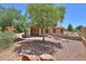The backyard is nicely landscaped with desert landscaping, a seating area, and a covered patio at 103 S Birdie Way, Casa Grande, AZ 85194