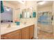Neutral-toned bathroom offers a spacious dual sink vanity and access to the shower and bedroom at 103 S Birdie Way, Casa Grande, AZ 85194