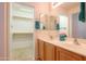 Bright bathroom featuring a double sink vanity and a walk in closet at 103 S Birdie Way, Casa Grande, AZ 85194